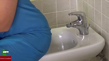 Masturbates her pussy with the water from the bidet